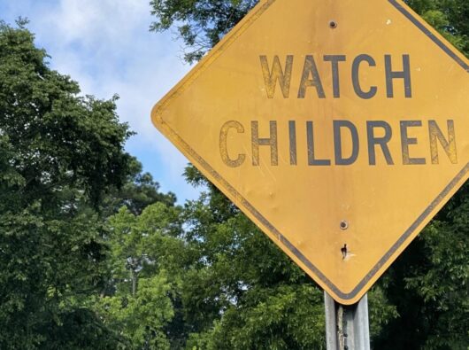 Faded caution sign: Watch Children